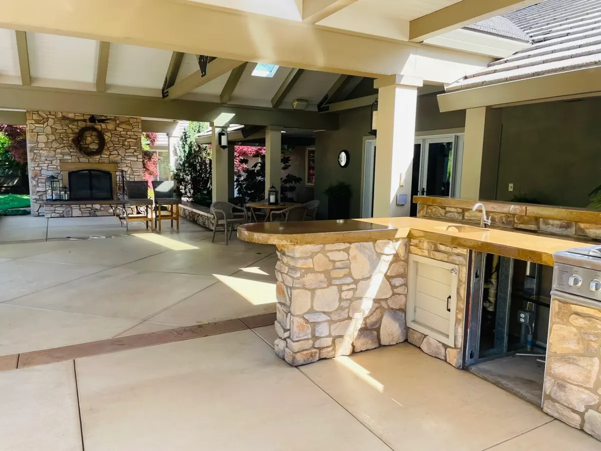 Custom outdoor living space with stone and concrete work